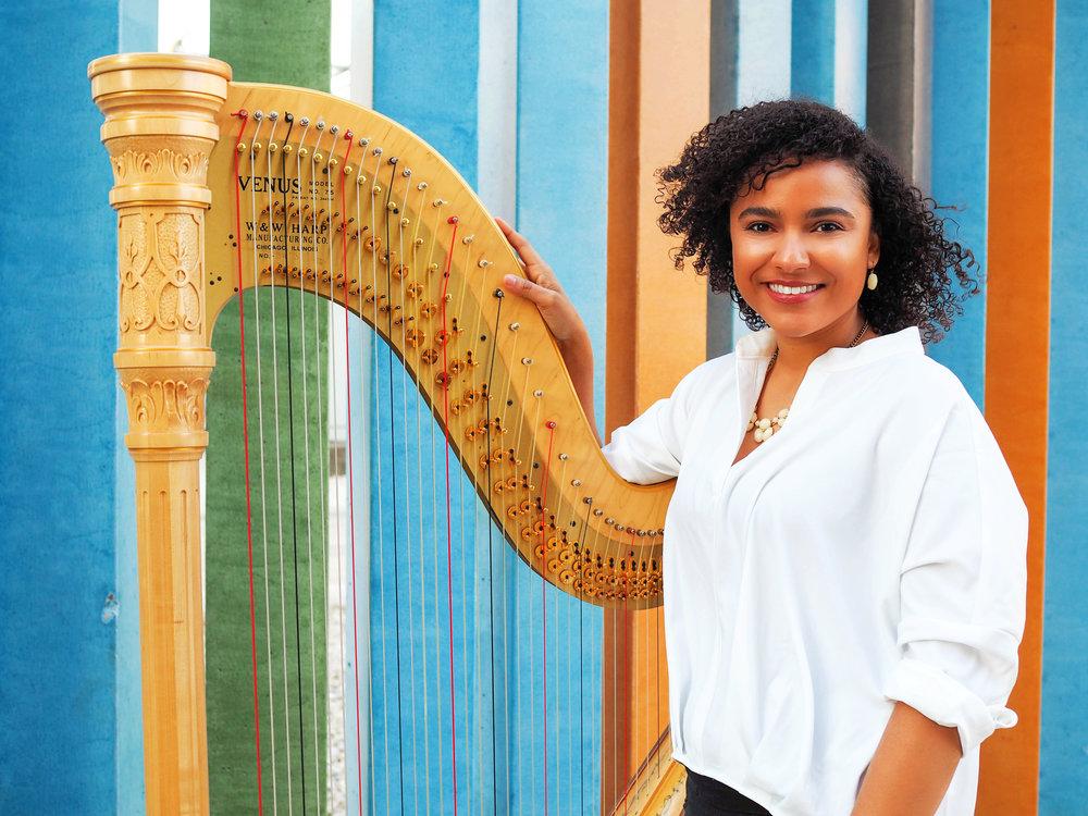 Mallory McHenry poses with harp