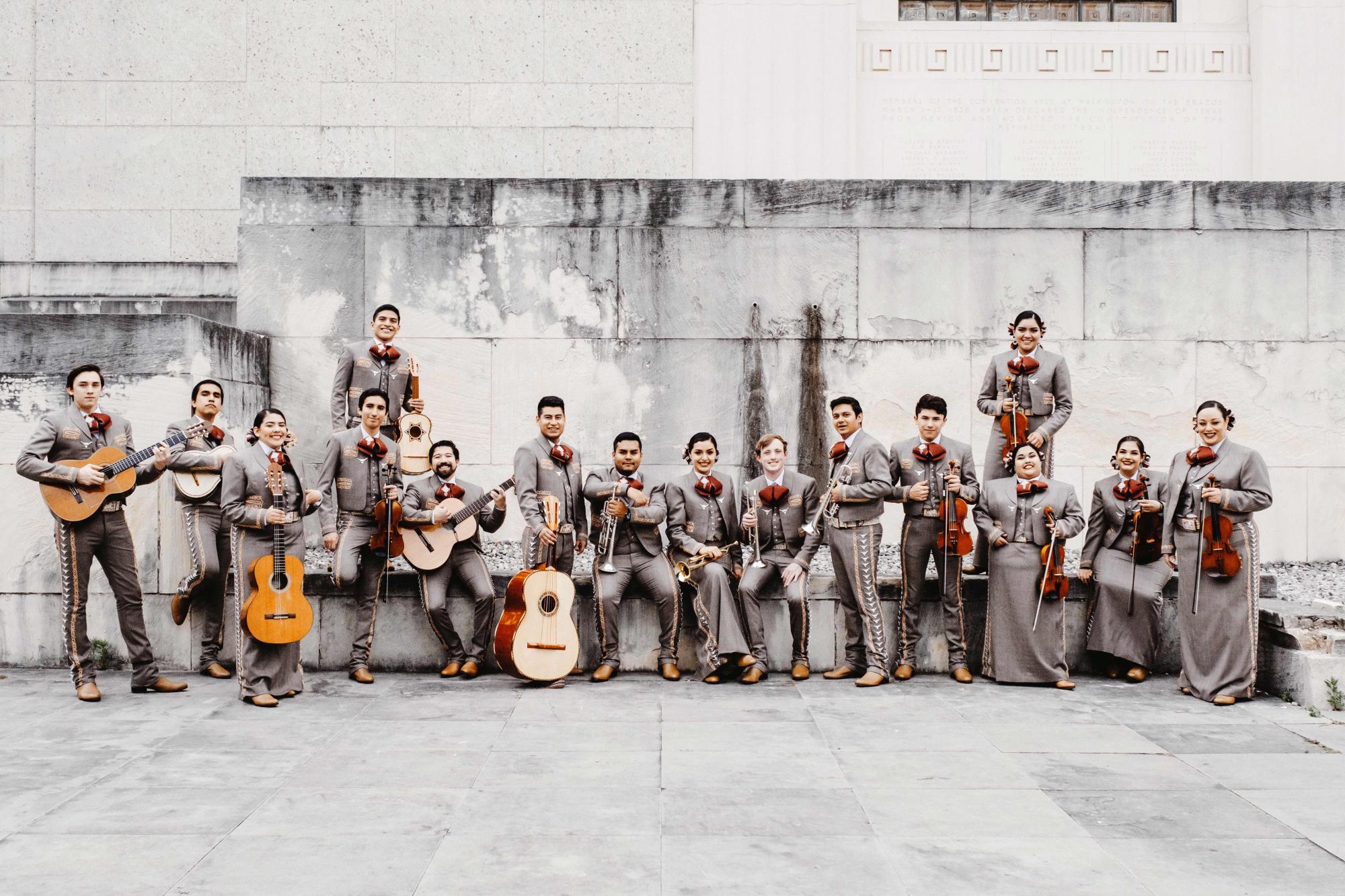 Students in the mariachi ensemble pose with their instruments