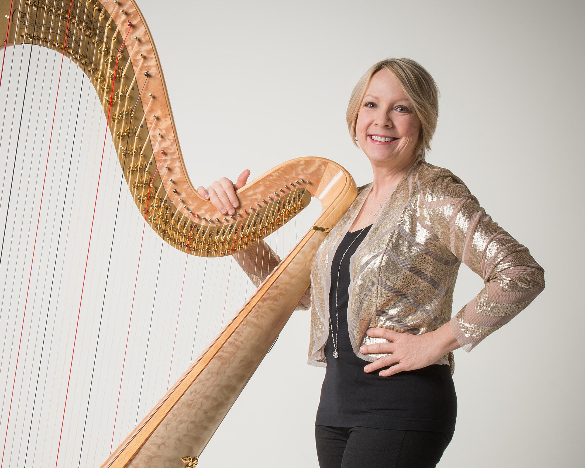 Delaine Leonard poses with harp