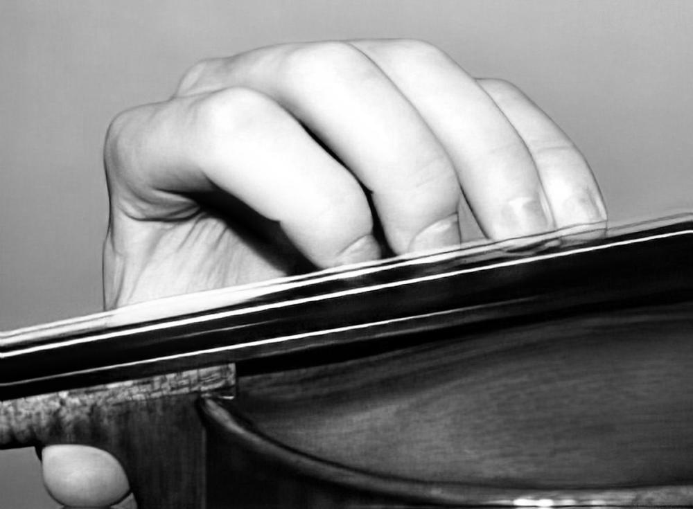 An image showing proper hand placement on violin strings.
