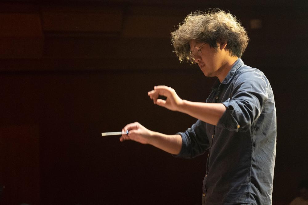 Student Zongheng Zhang conducts an opera