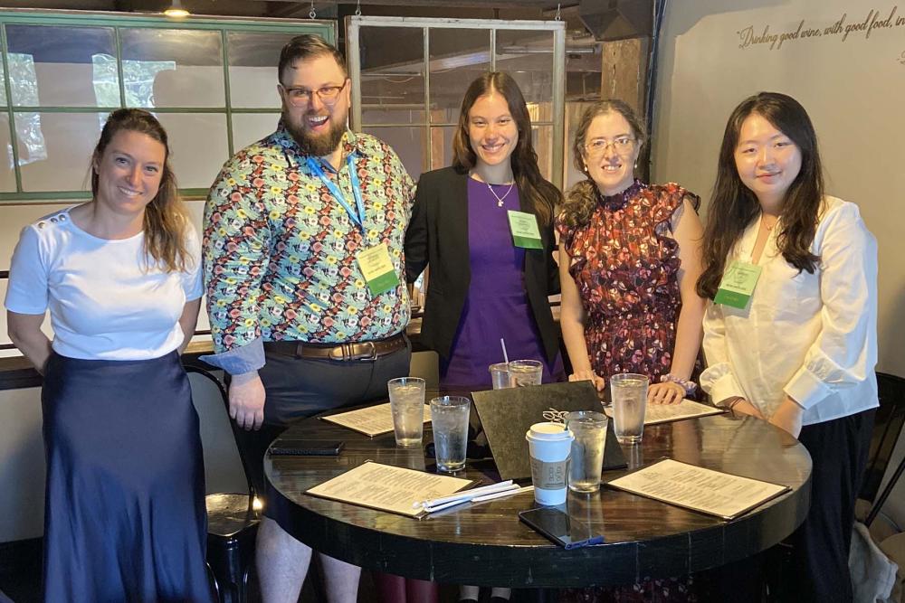 Five people happy at a cafe table