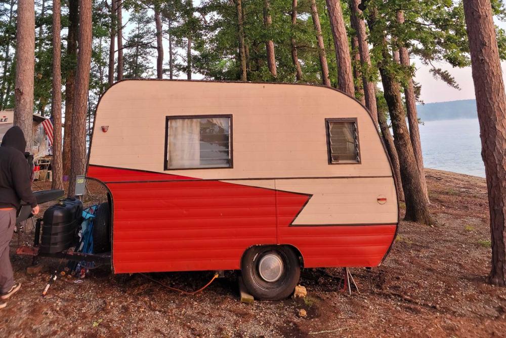 A camper trailer in the woods