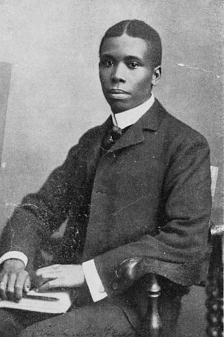 Paul Dunbar sitting at a desk