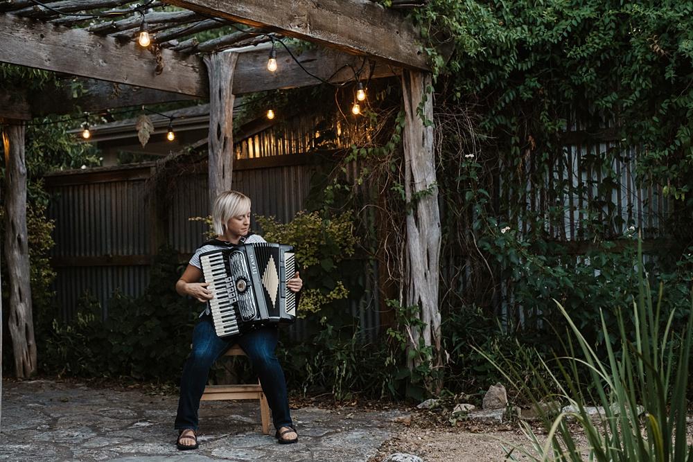 Chelsea Burns plays her accordion at her home in Austin