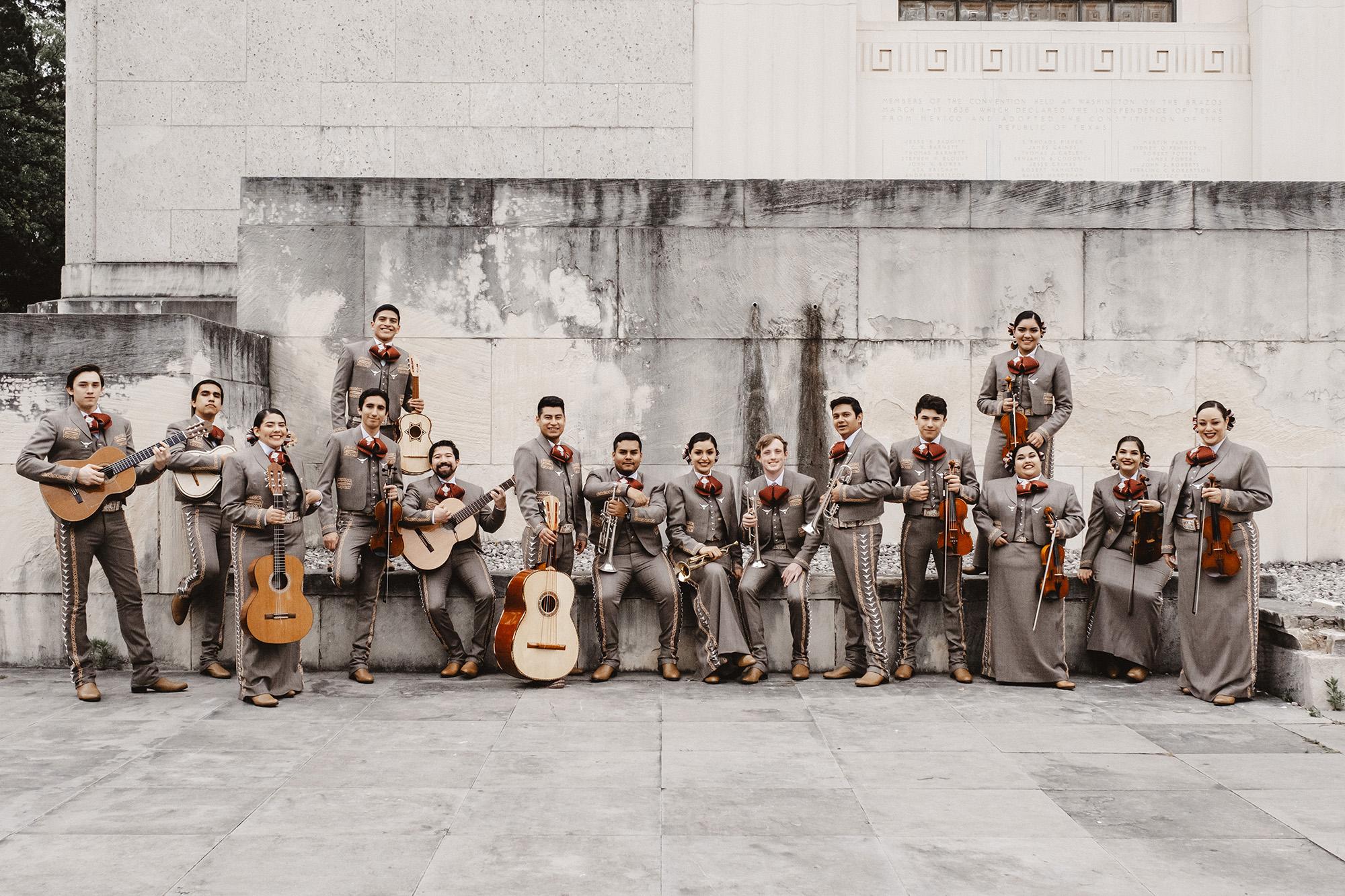 UT Mariachi pose with instruments on the UT Campus