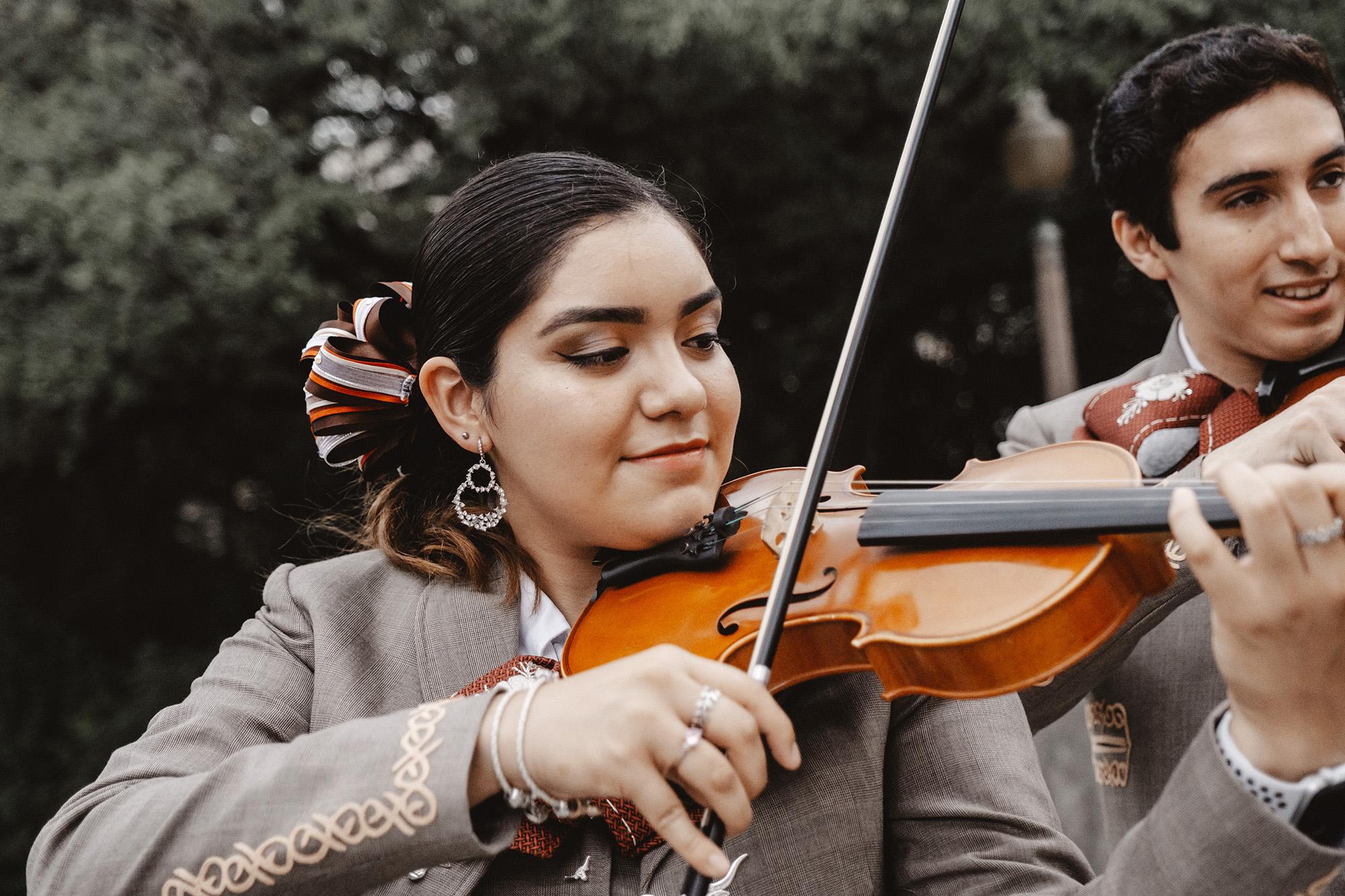 Female violinist performing with the UT Mariachi