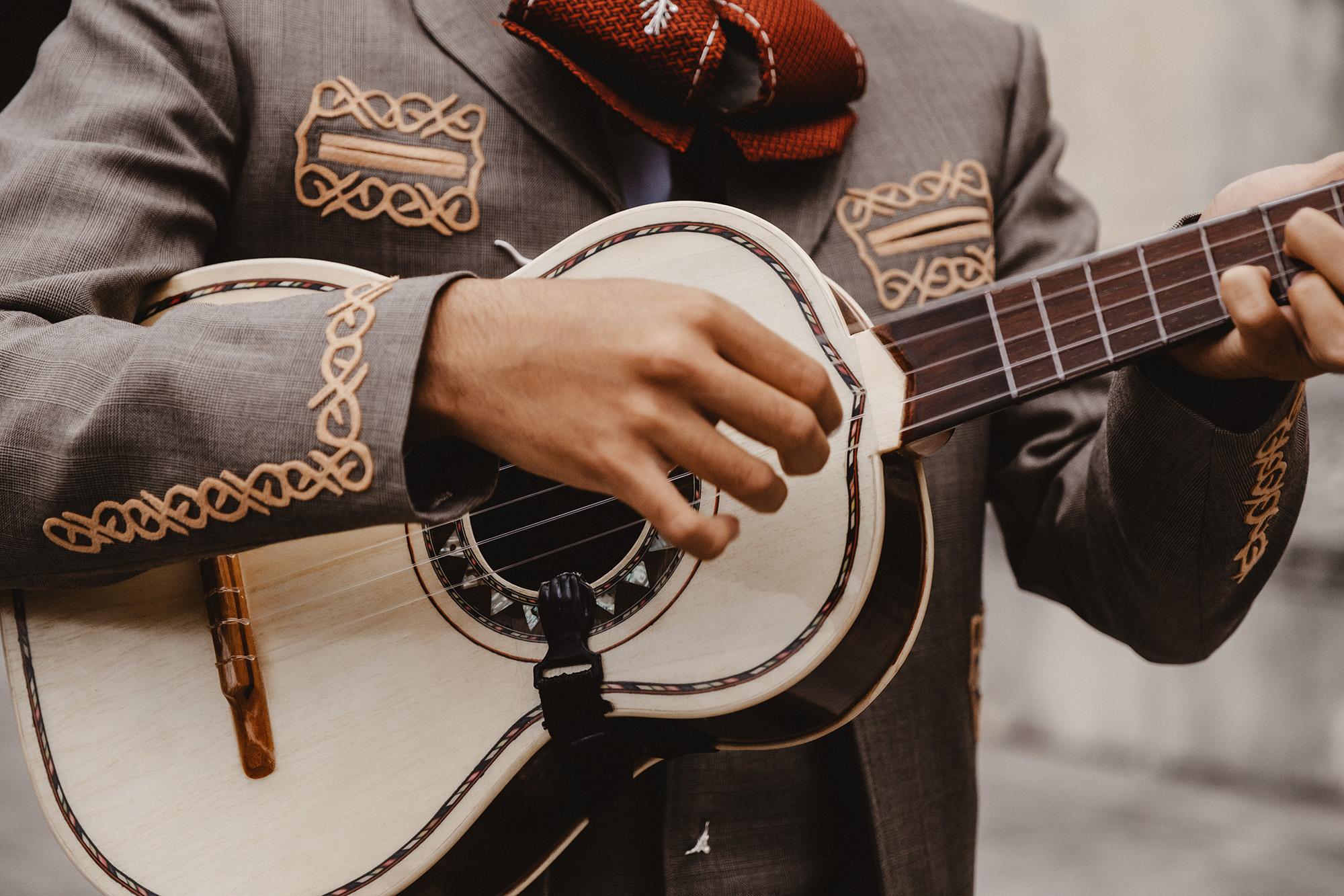 Close up on guitar player's hands as he performs