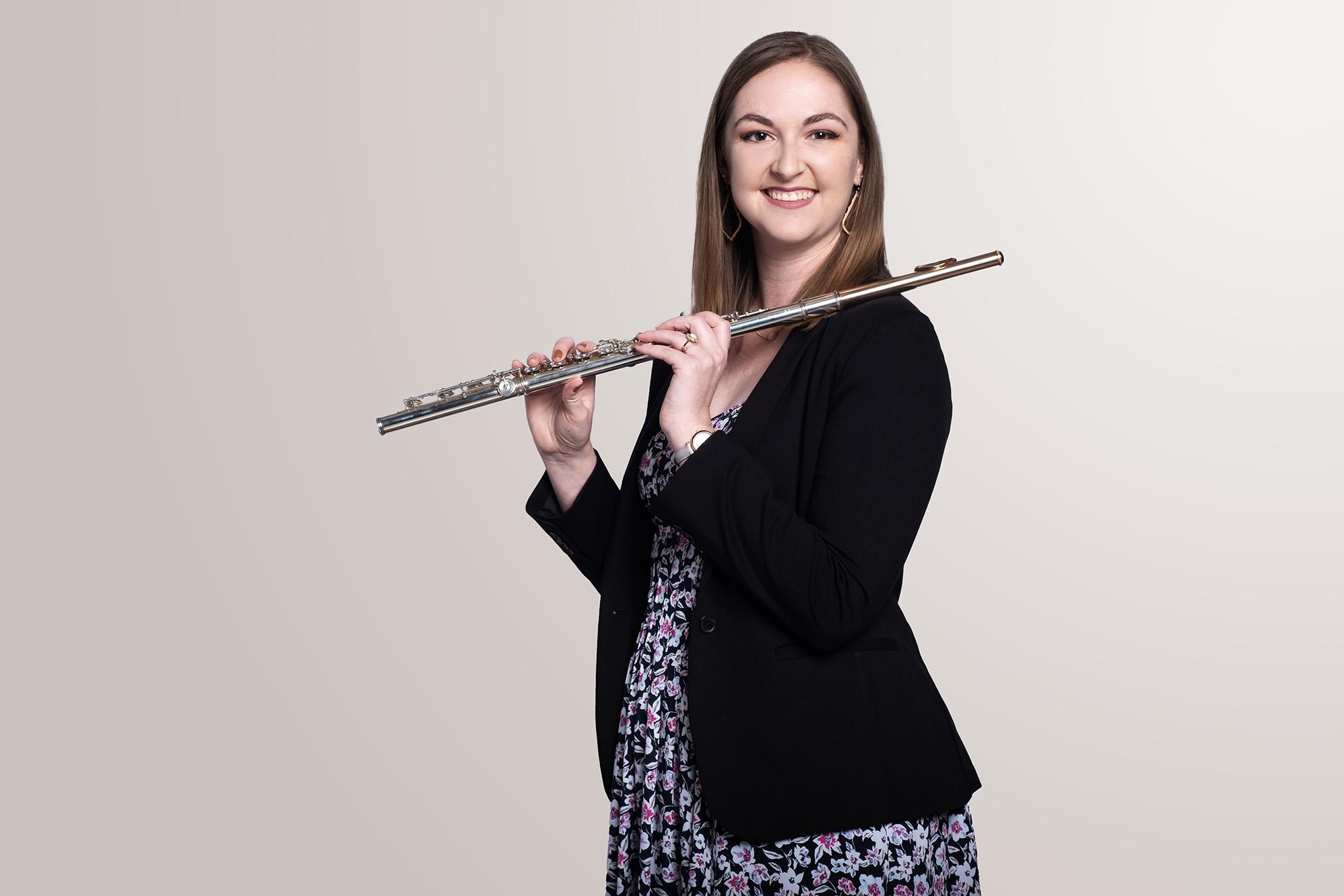 A flute player holding her instrument