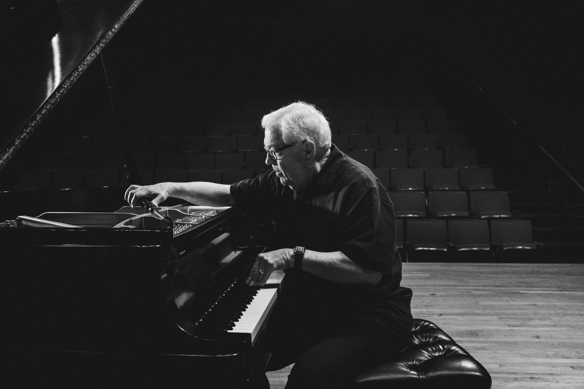 Charles Ball sits at piano in Bates Recital Hall. Photo by Nathan Russell