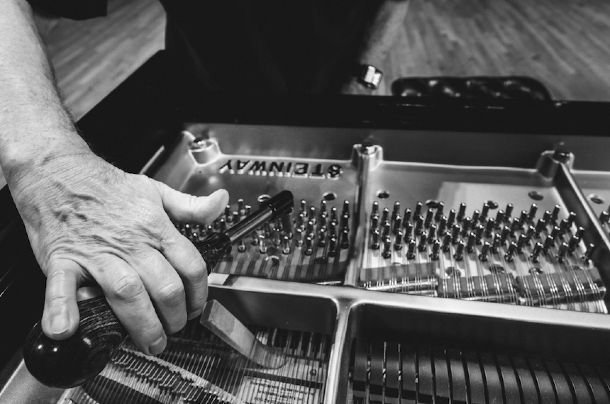 Charles Ball tuning a piano. Photo by Nathan Russell