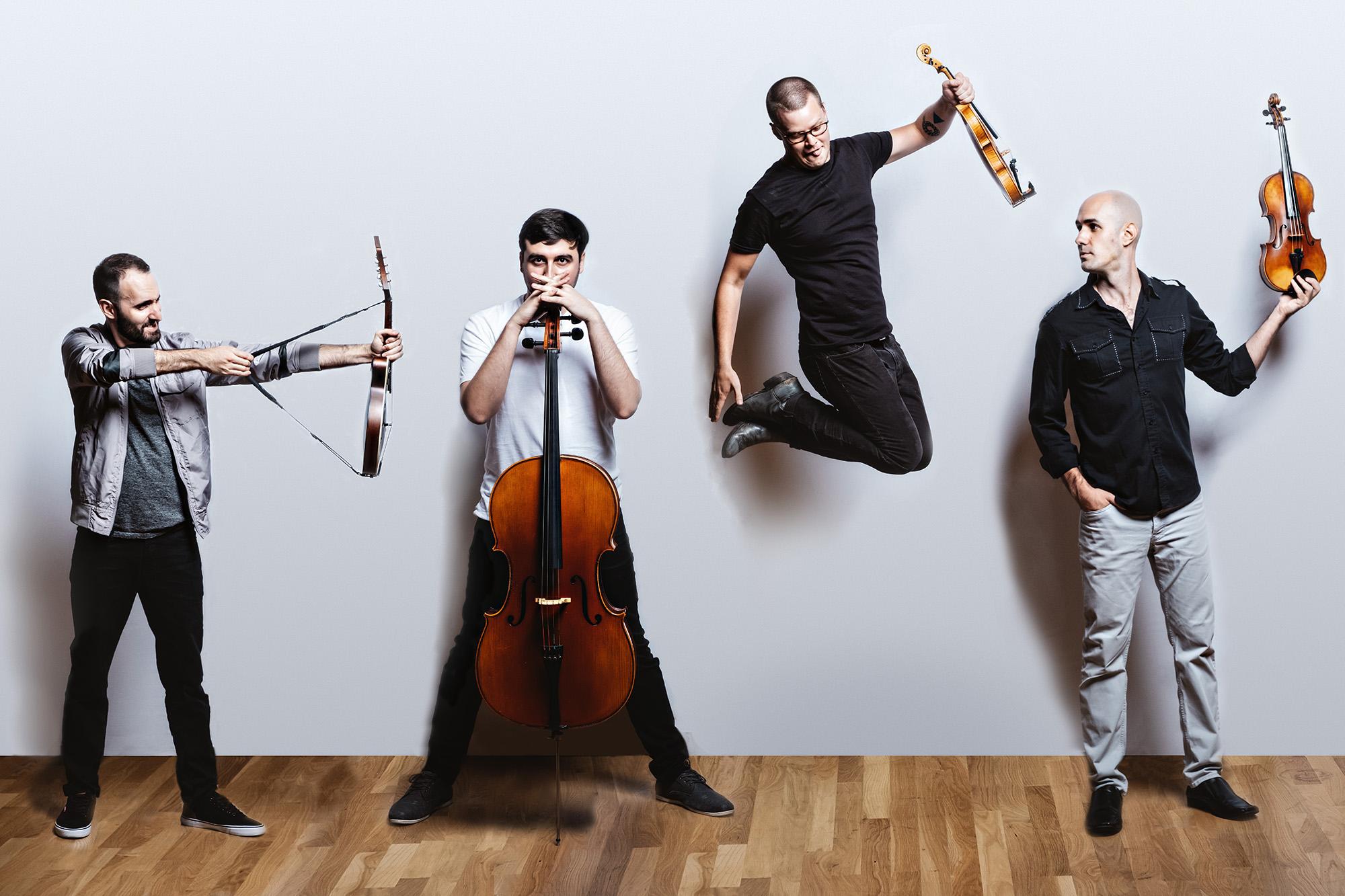 invoke posing humorously with their instruments in front of a white wall