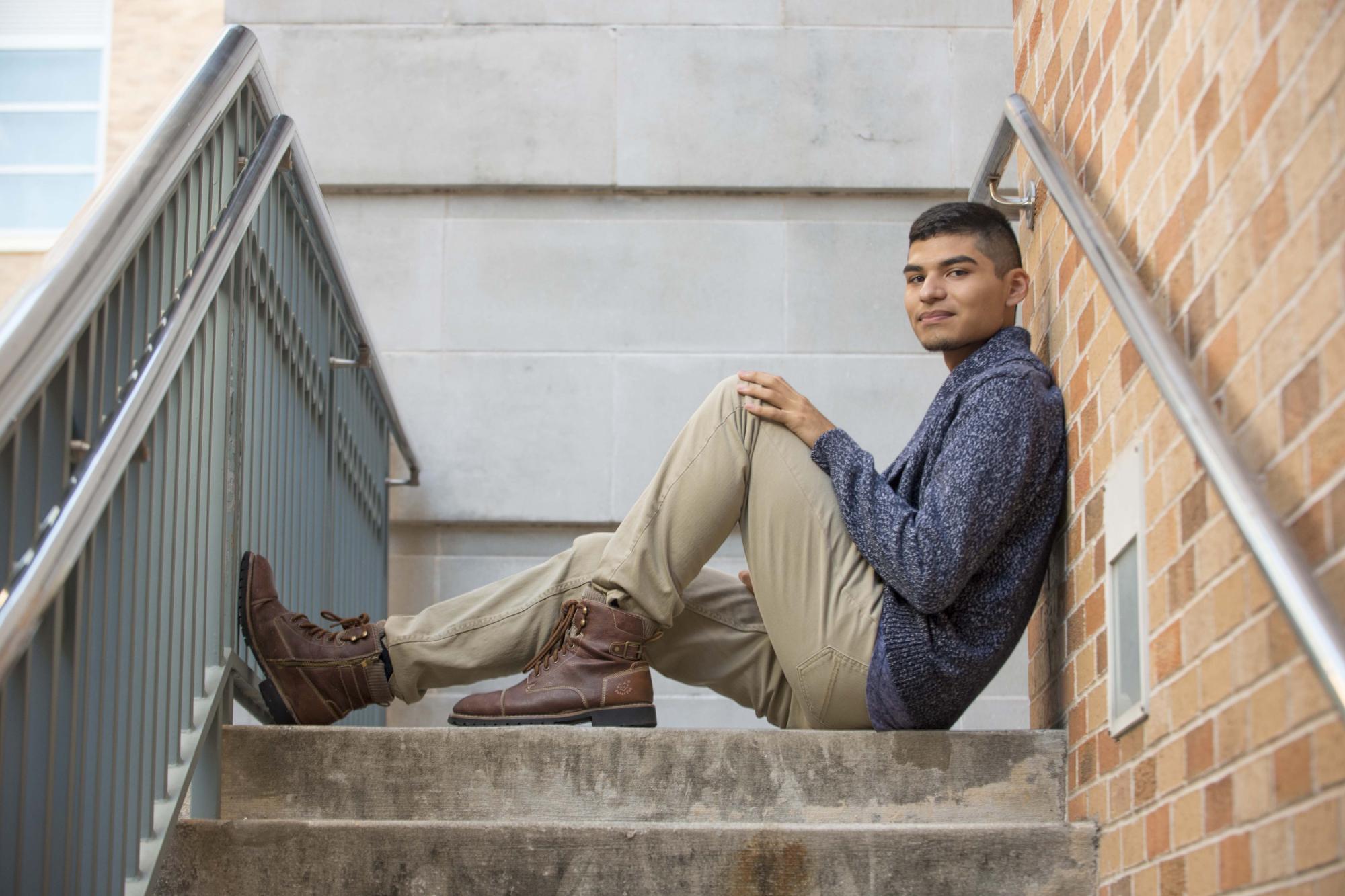 A UT student, hanging out on a staircase on the UT Campus