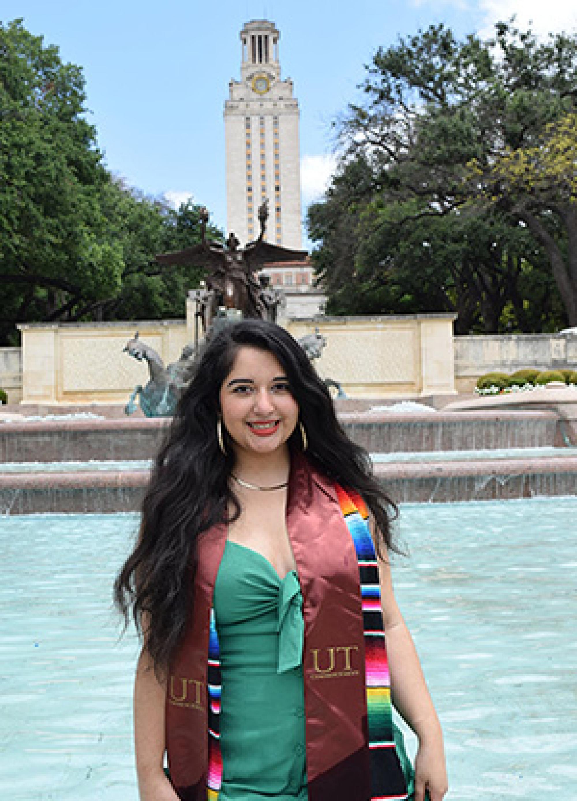 Woman standing in graduation regalia