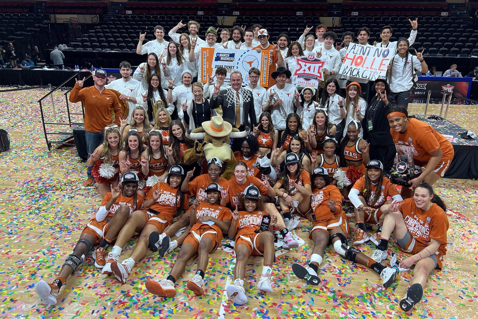 A Group photo of the pep band with Beevo and Cheerleaders on the basketball court