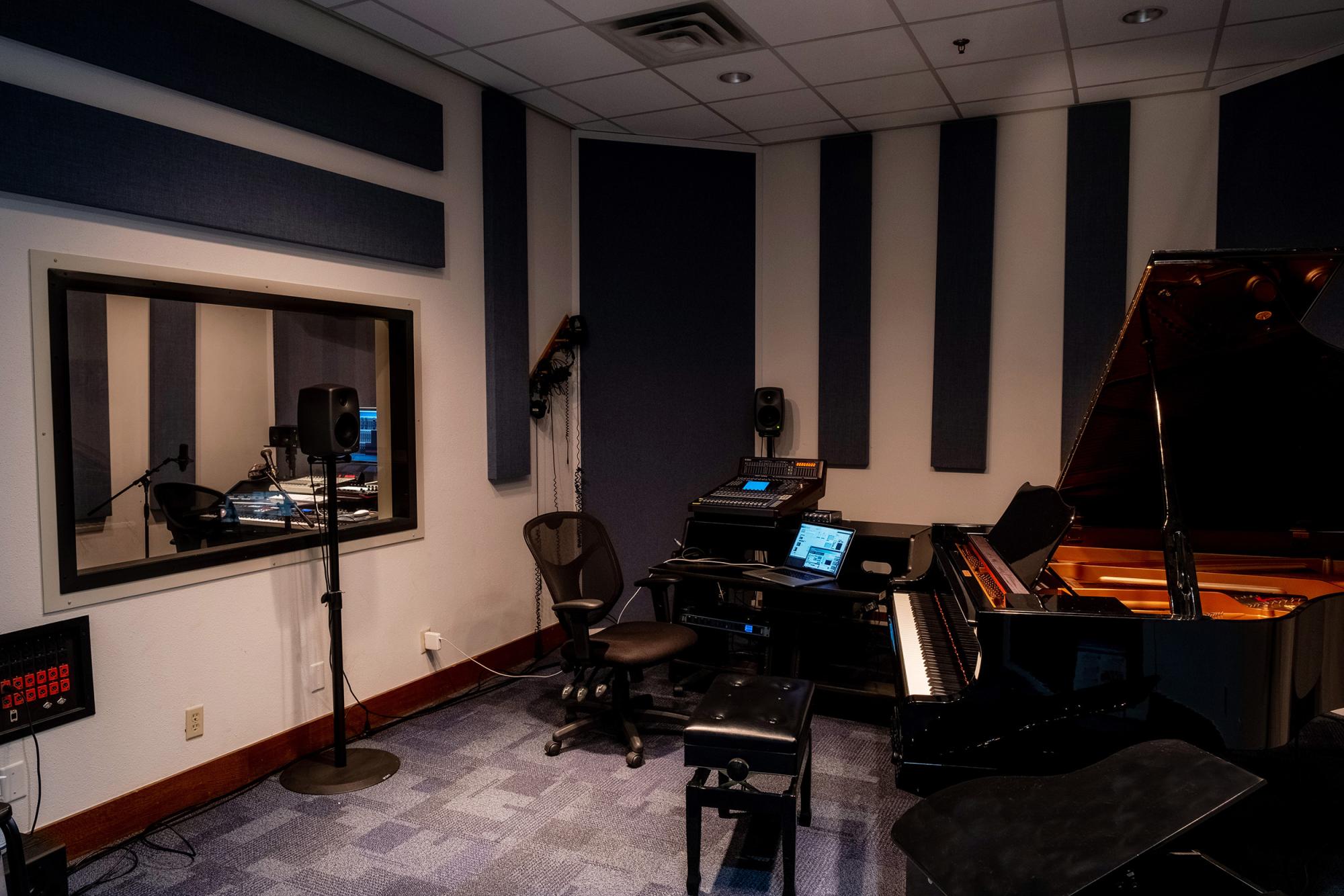 Studio space with a grand piano and recording equipment