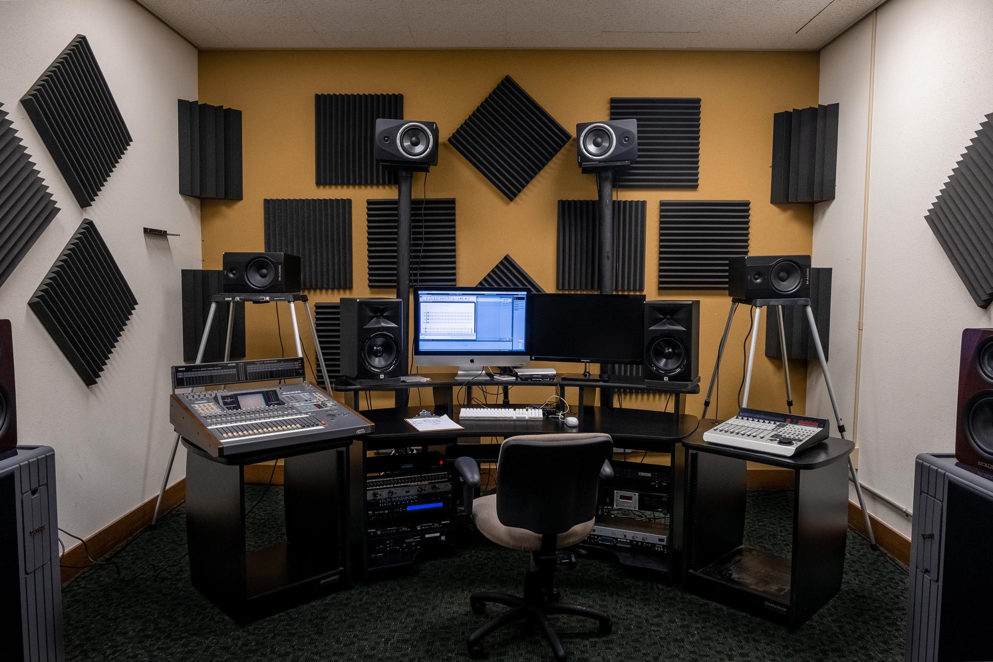 A large room lined with acoustic tiles, with an extensive amount of electronic equipment.