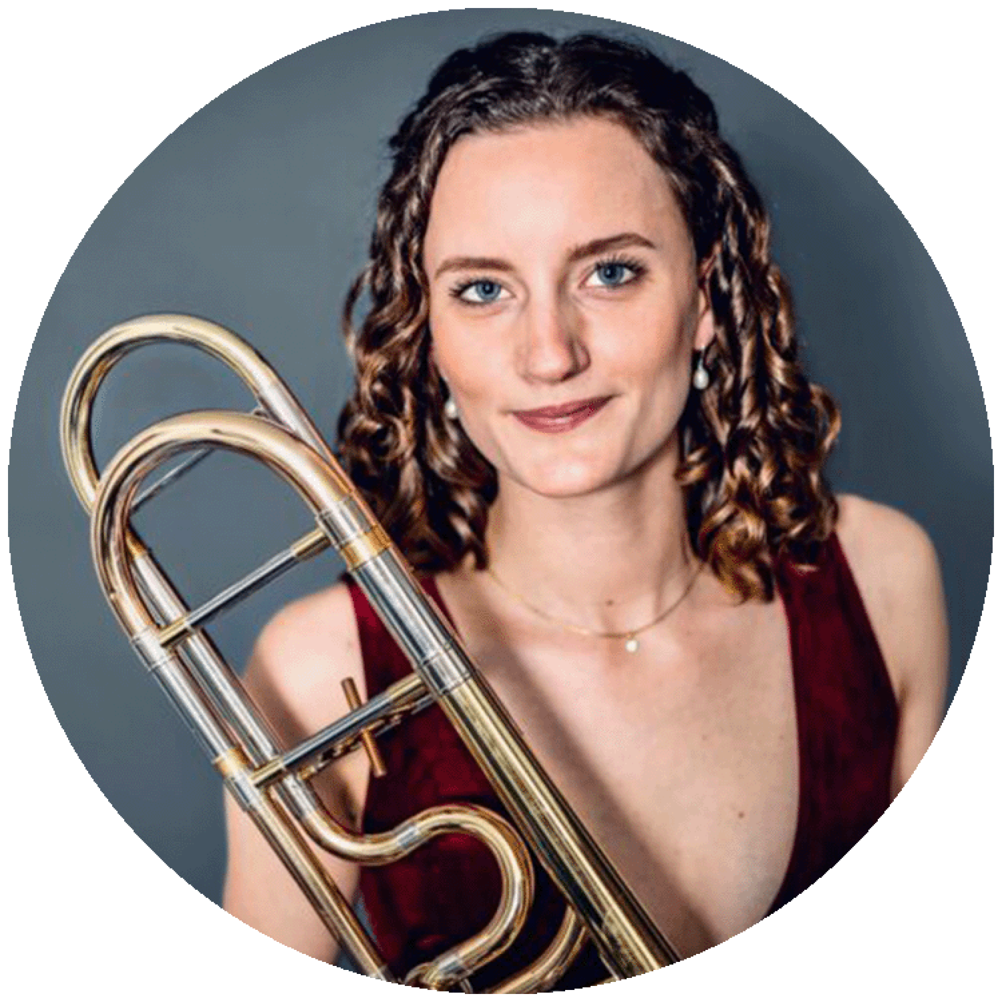 a headshot of Lauren Casey Clyde with her trombone