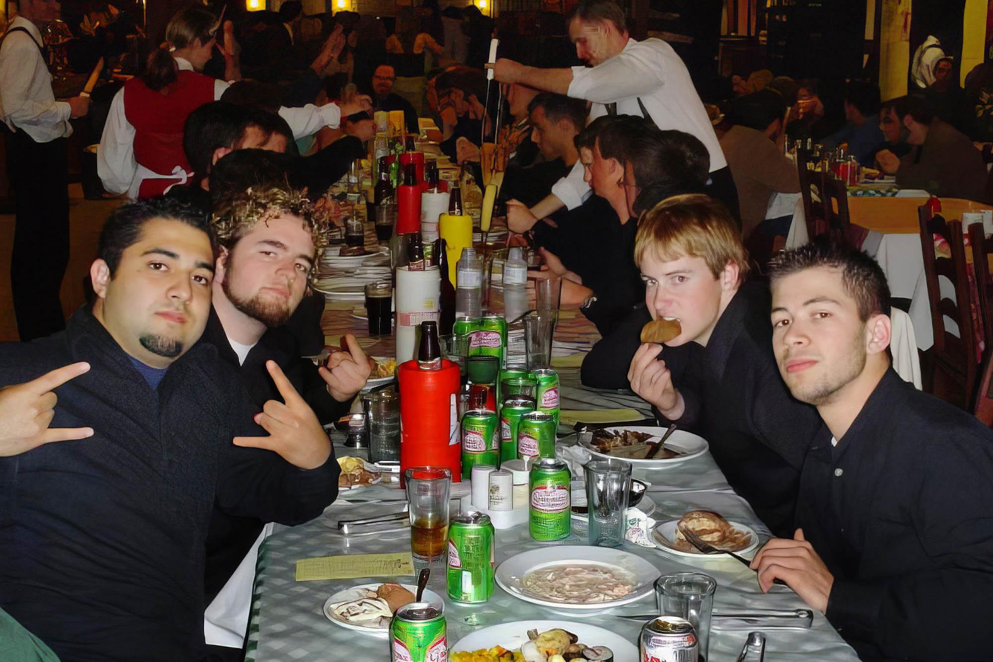 students enjoy a group meal and smile for the camera