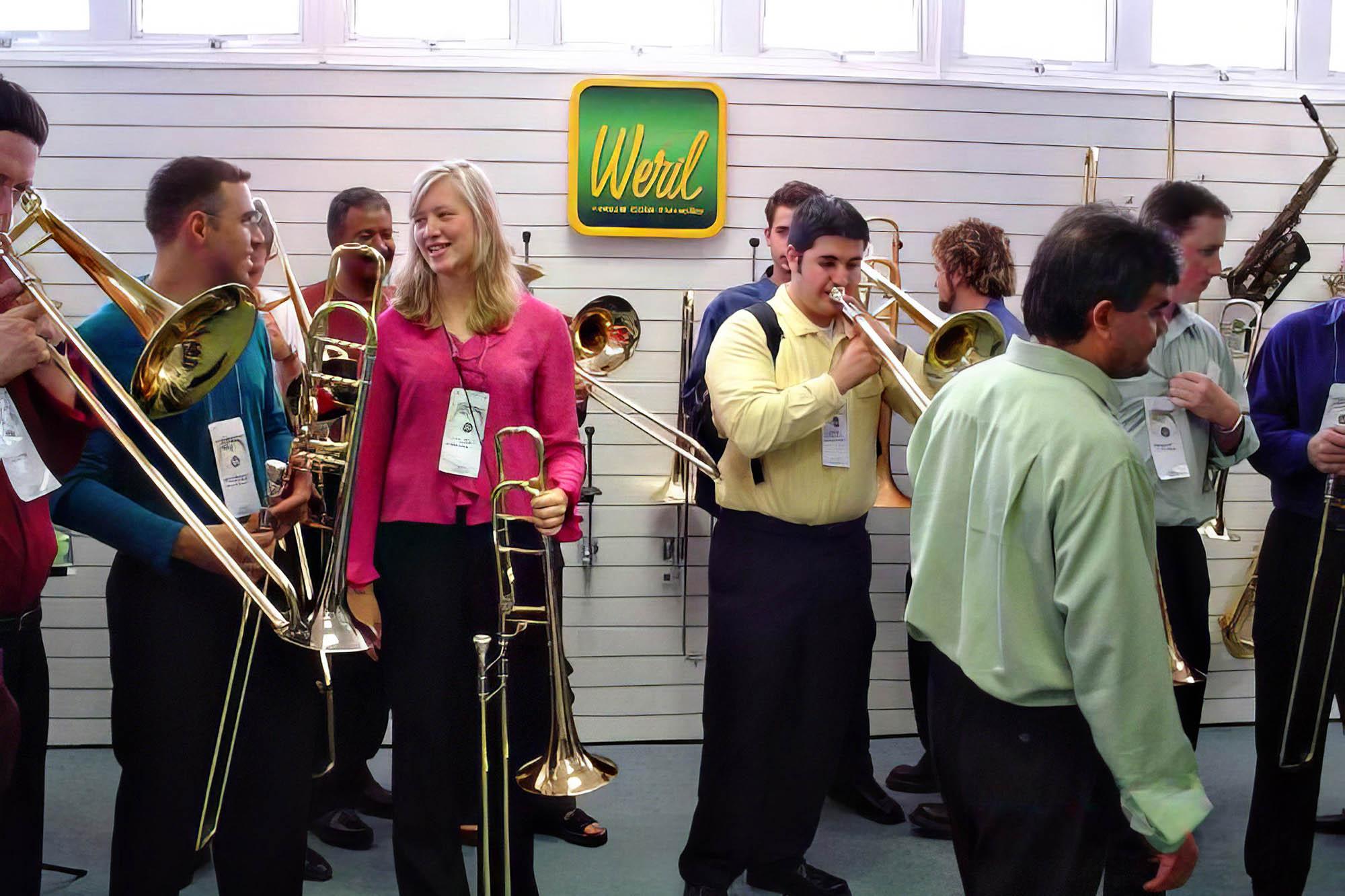 Students try out trombones at a vendor booth at the international trombone festival in Brazil