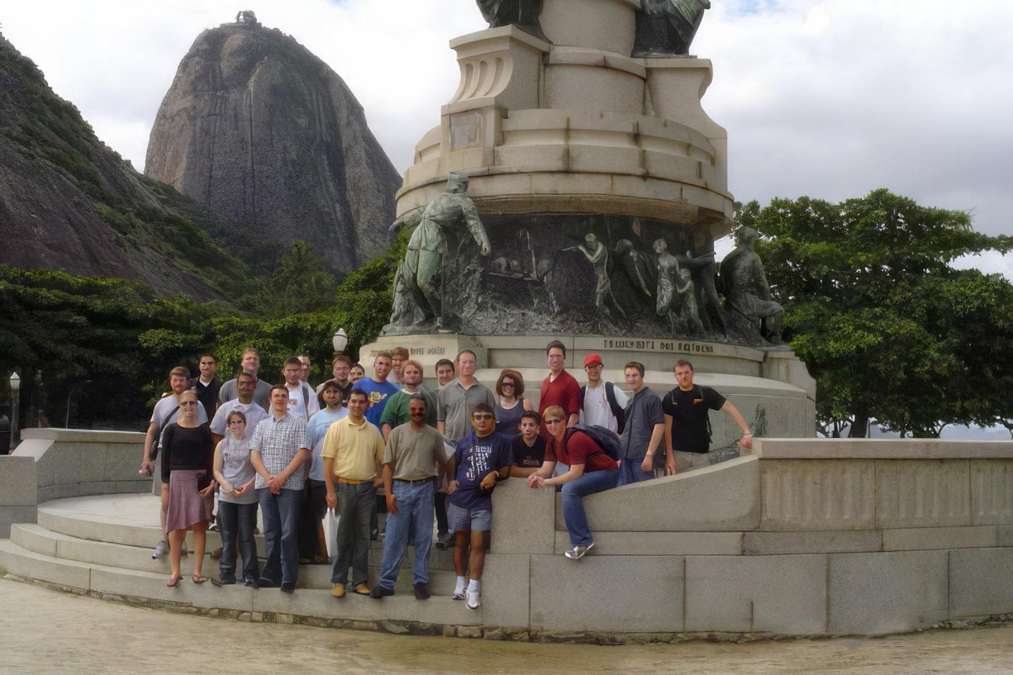 The trombone choir poses for a casual photo at the base of an unidentified monument in Brazil