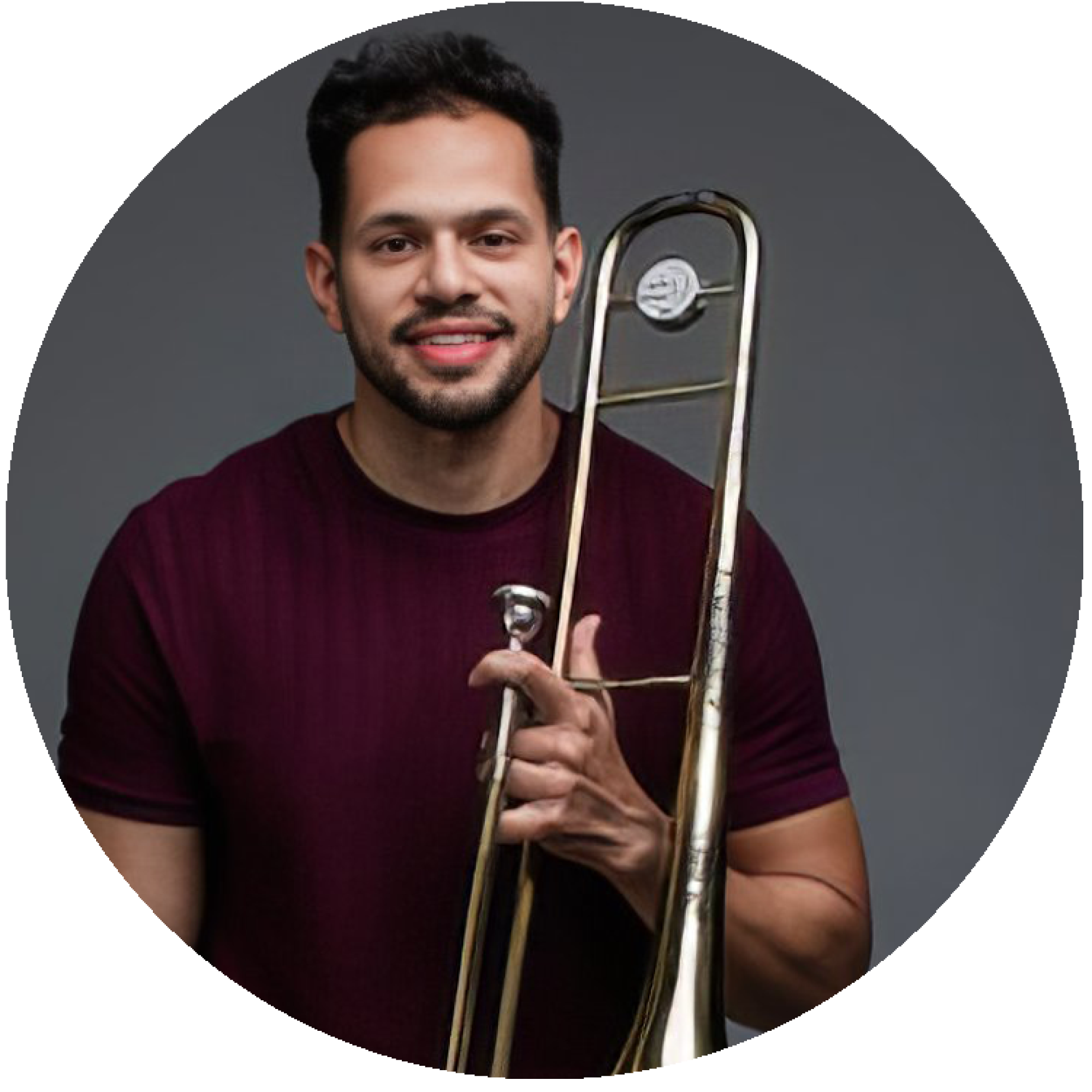 a headshot of Felipe Brito holding his trombone