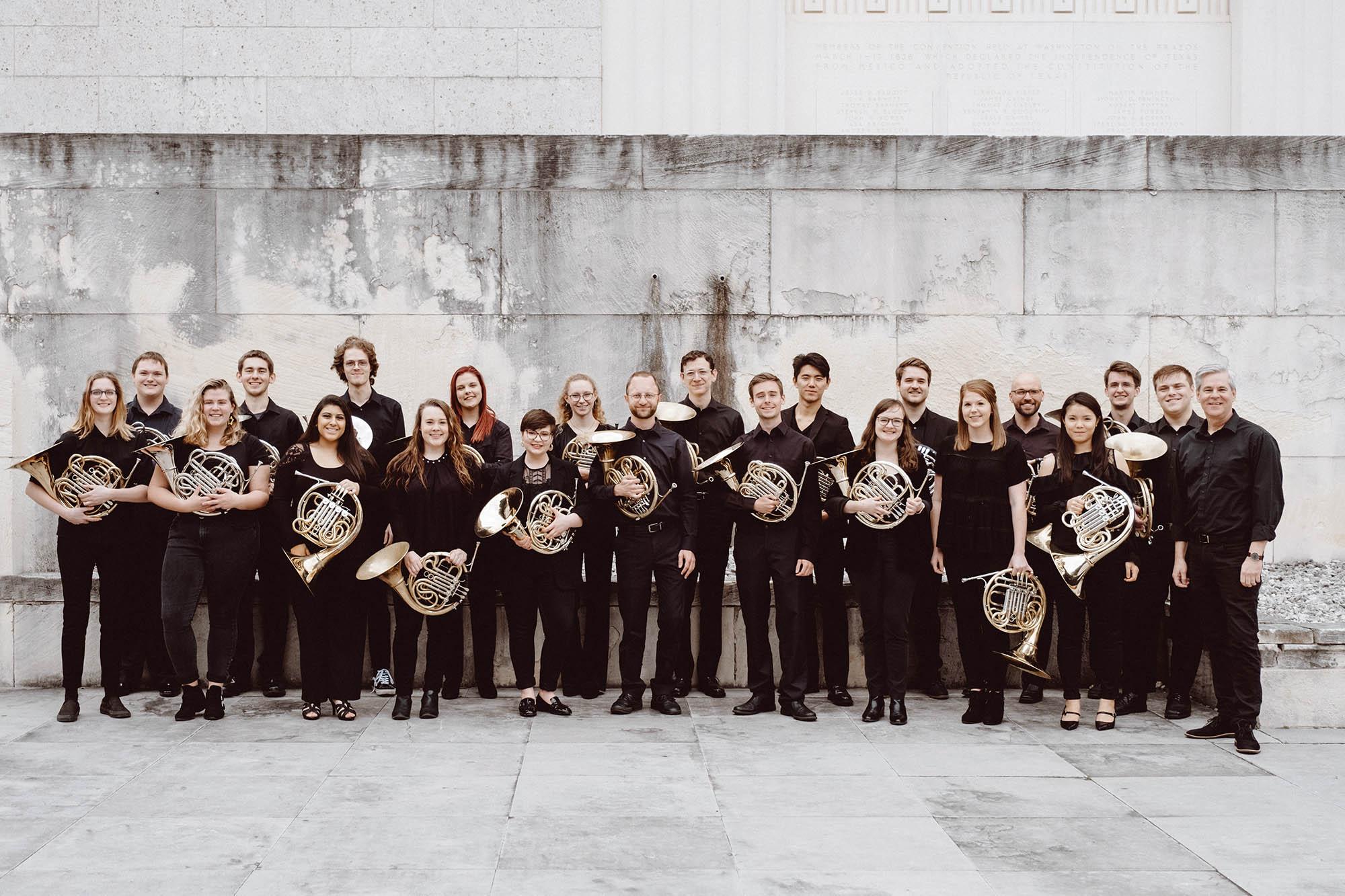 the 2019 horn studio with their horns, in a white stone courtyard.  