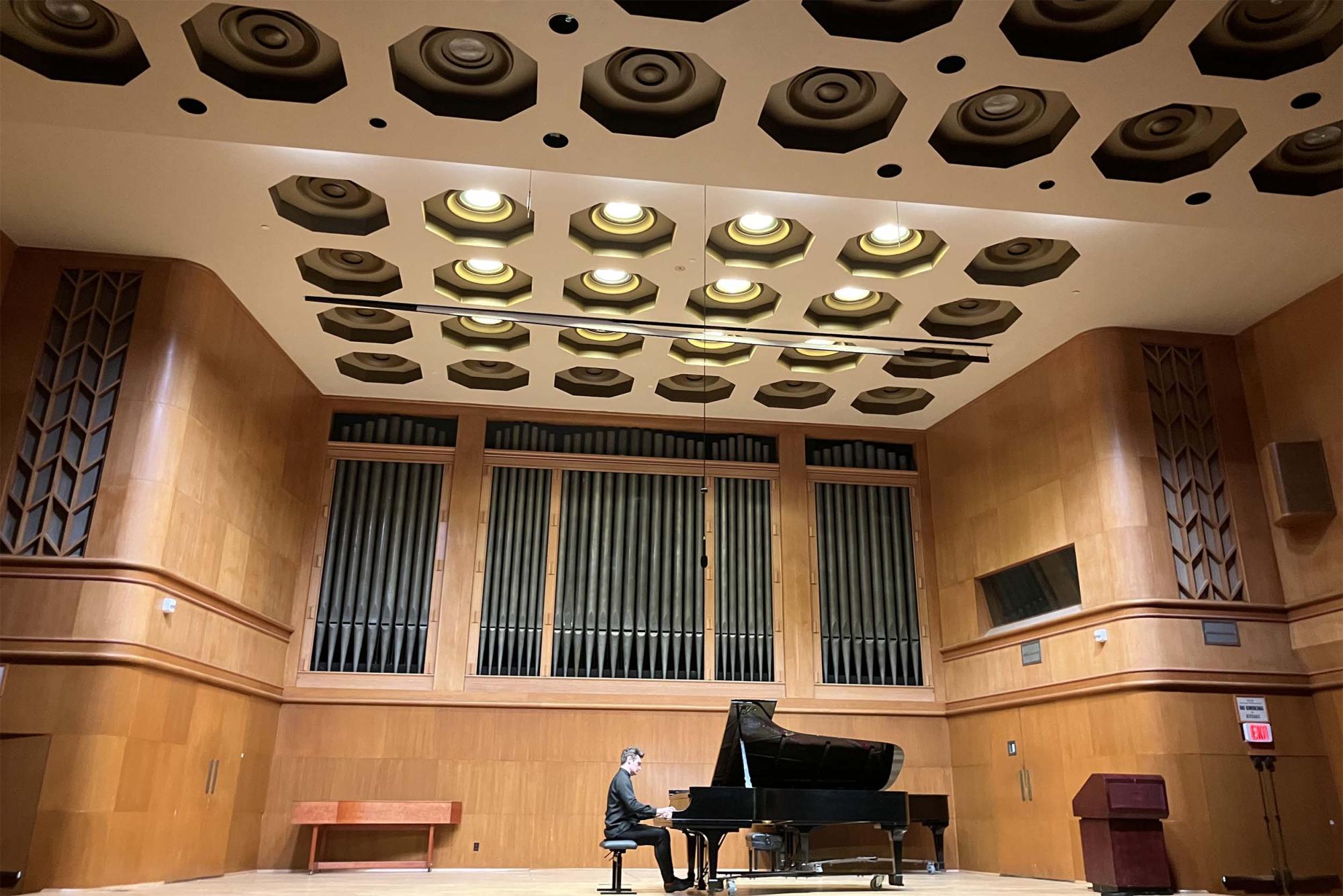 Artem Kuznetsov playing the piano on stage