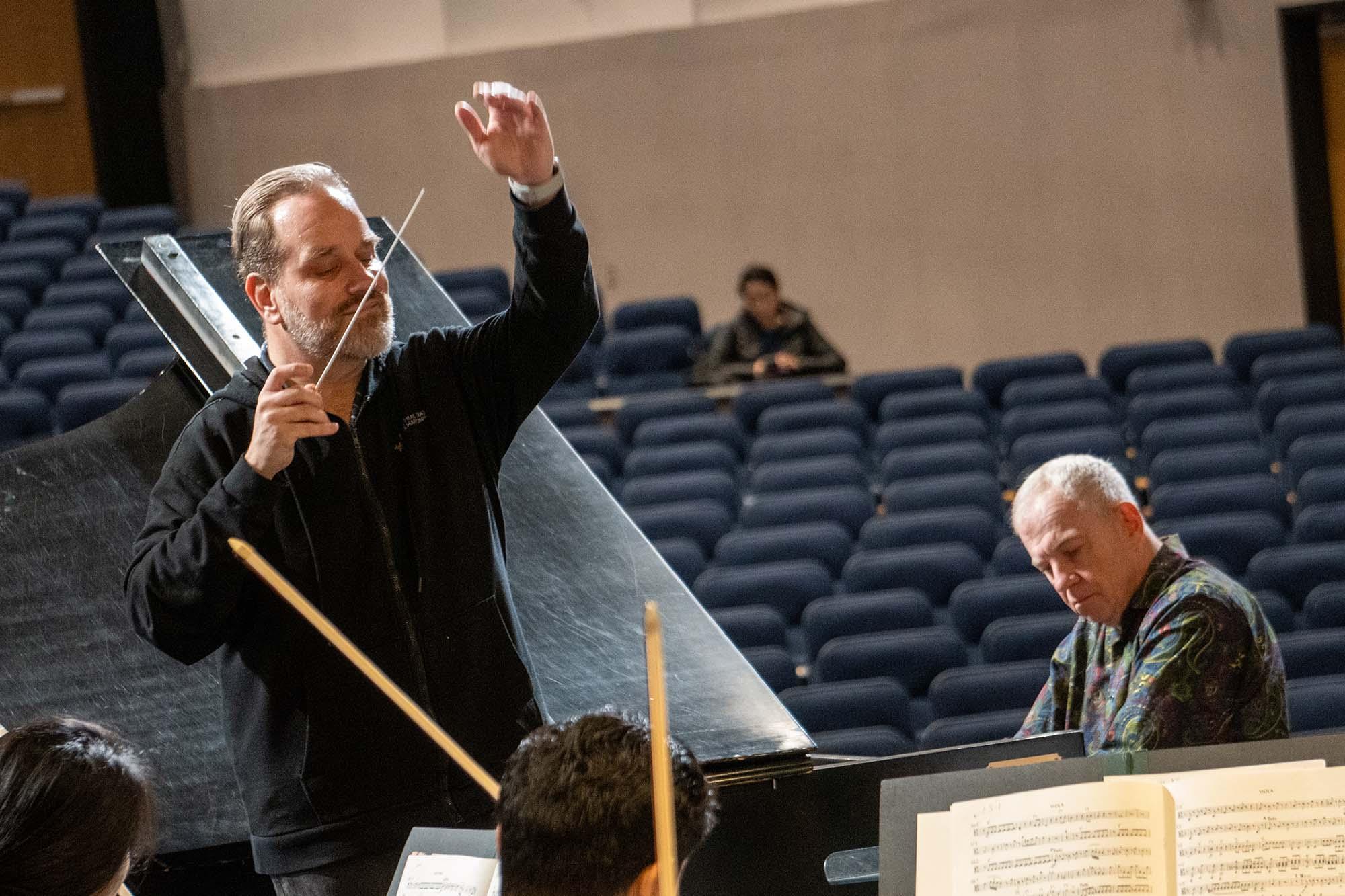 Anton Nel Playing the piano on the stage with conductor Stefan Sanders