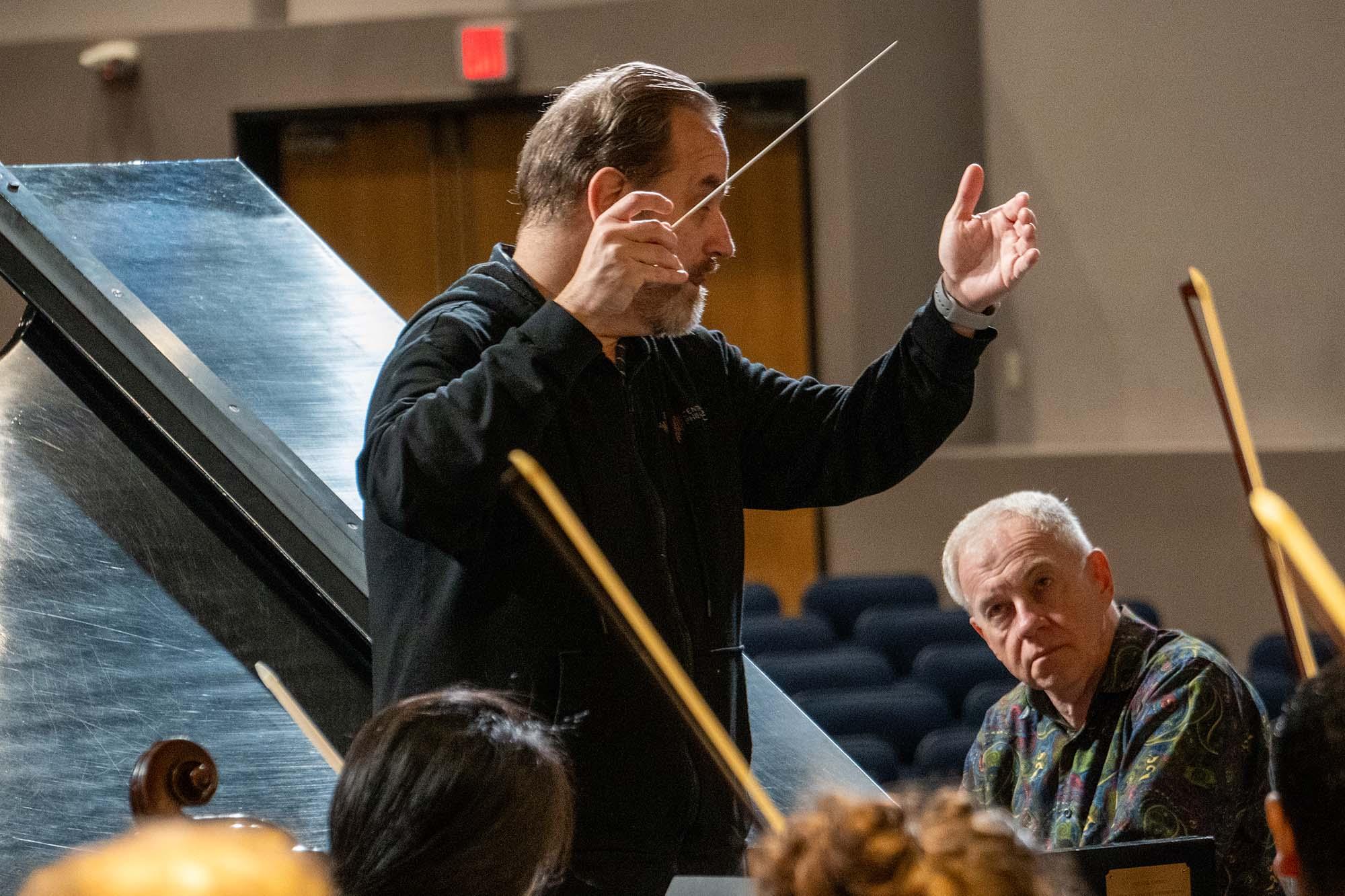 Anton Nel Playing the piano on the stage with conductor Stefan Sanders