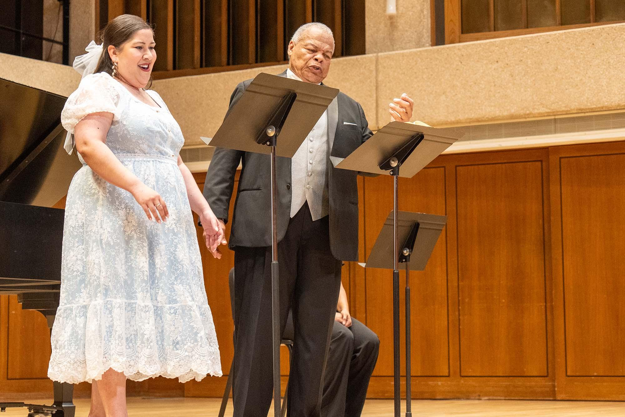 Two opera singers sing on stage