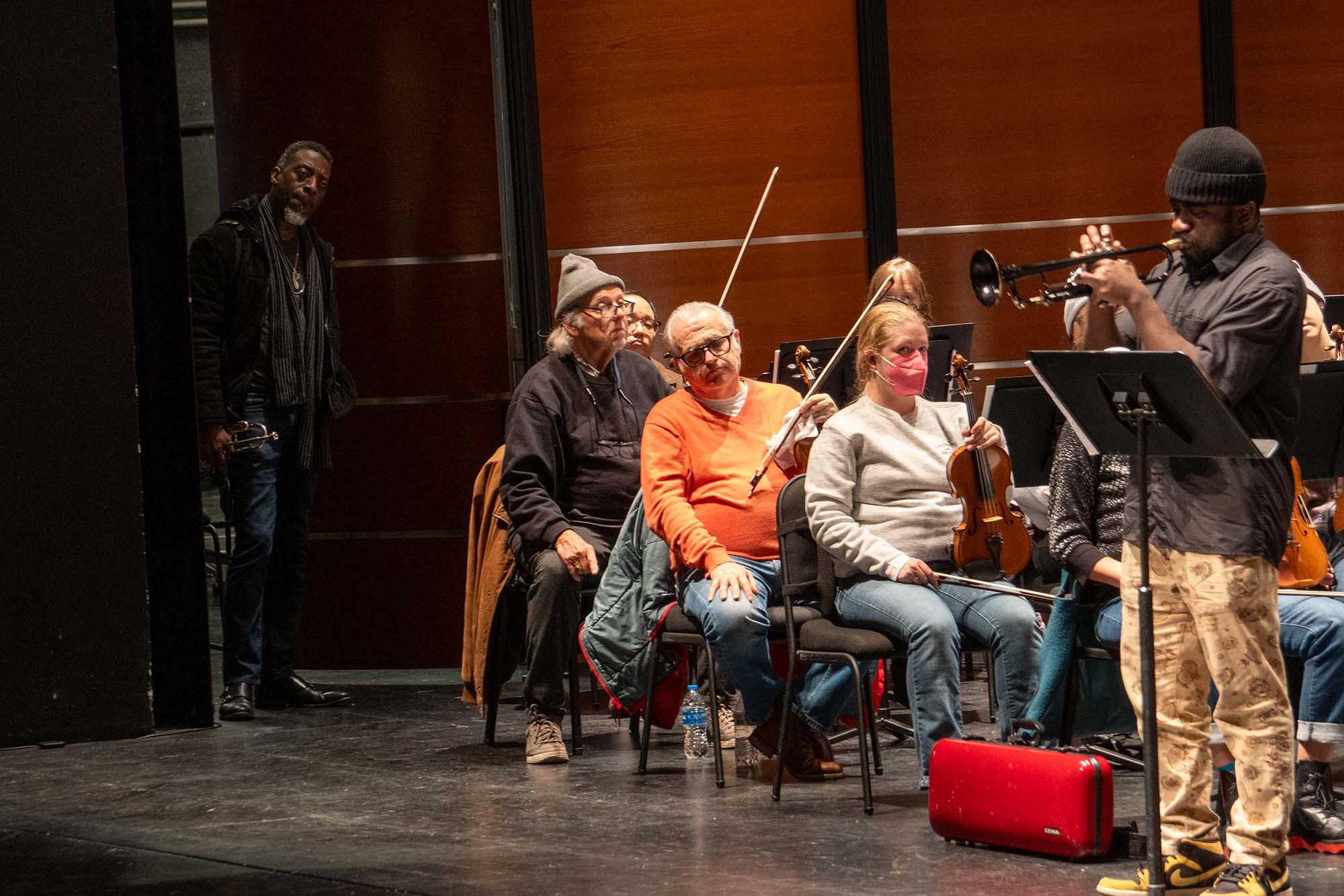 Ephraim Owens waits backstage as Giveton Gelin plays trumpet