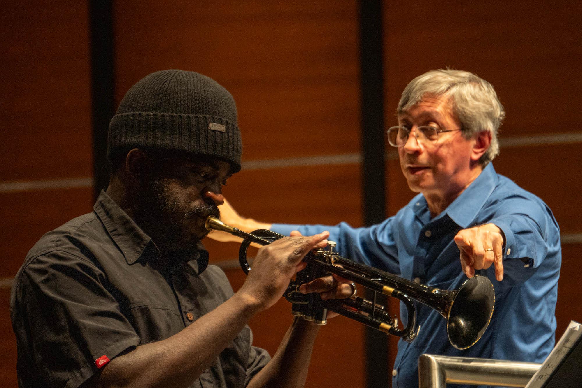 Giveton Gelin plays the trumpet with conductor Peter Bay in background