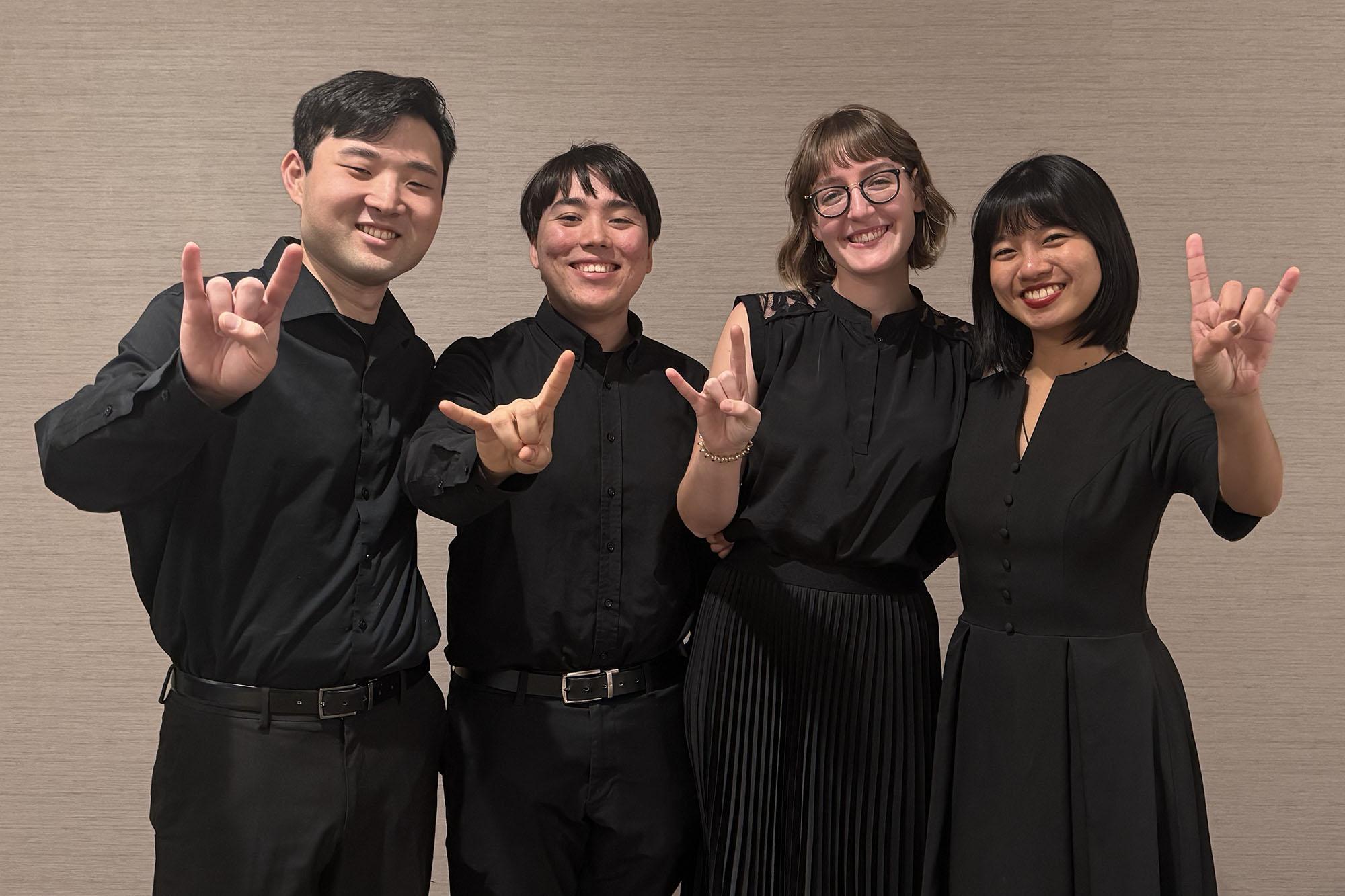 Soha quartet  Mei Liu (violin), Chloe Yofan (violin), Thomas Gougeon (viola), and Katusaki Arakawa (cello) showing the hook em sign