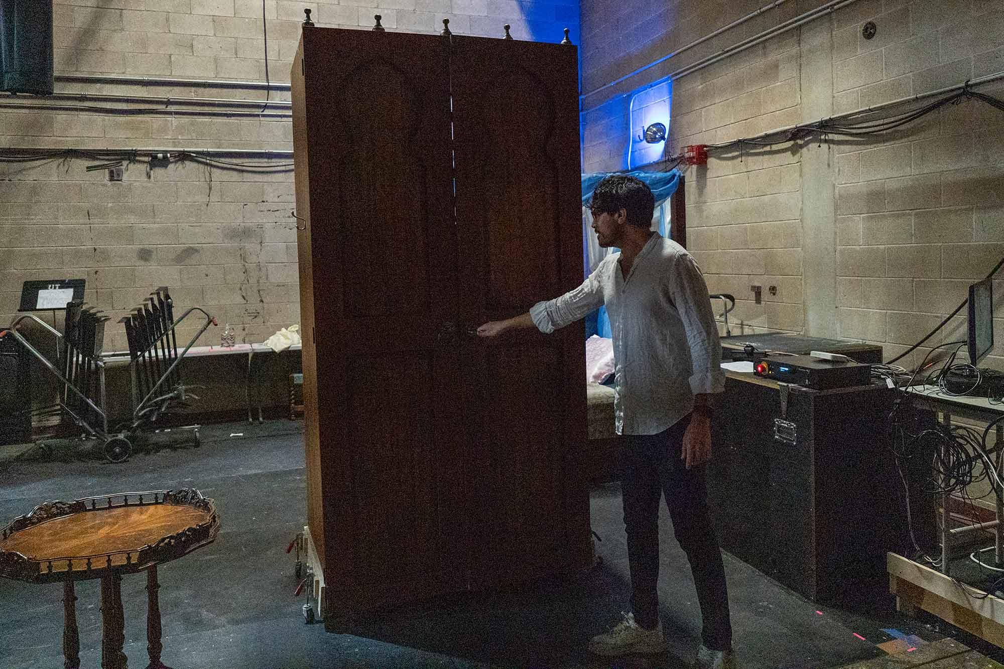 A man showing a closet backstage