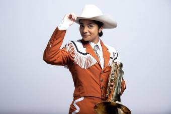 Longhorn Band Player tipping her cowboy hat