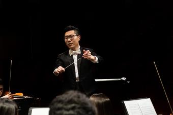 Male Conductor conducts the University Orchestra