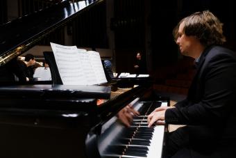 a jazz pianist performs on stage with the Jazz Orchestra