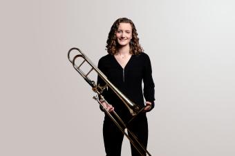 a trombone player holding her instrument.