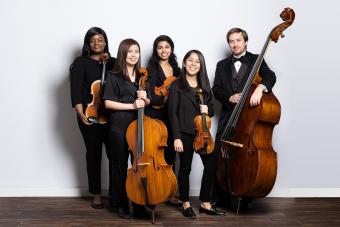 a group of string players with their instruments in concert attire