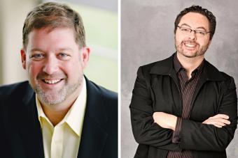 On the left, a man wearing a yellow shirt and black jacket smiles. On the right, a man wearing a brown shirt and black jacket smiles and crosses his arms. 