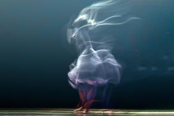 A blurred image of a dancer turning in a skirt.