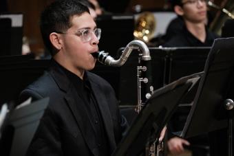 A bass clarinet player is ready for his musical entrance