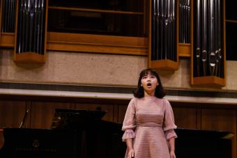 A singer performs on the Bates Recital Hall Stage.