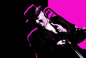 Black and white photo of Michael Dease wearing a hat and holding his trombone in front of a magenta and black background.