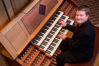 Alvez Barkoskie IV sits in front of an organ