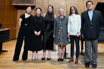6 people standing on stage