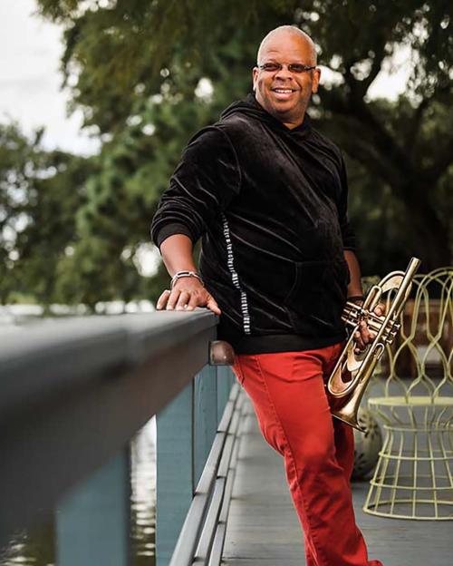 A portrait of Terrence Blanchard with his trumpet