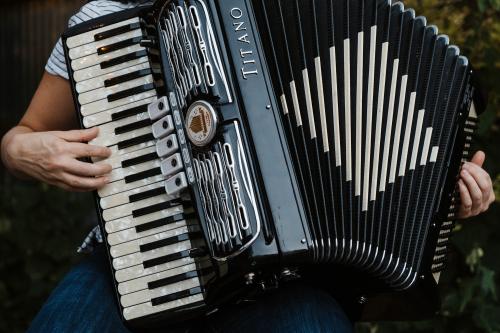 Close up of hands playing an accordion