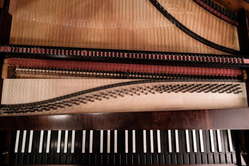 Close up of a pianoforte key bed and strings